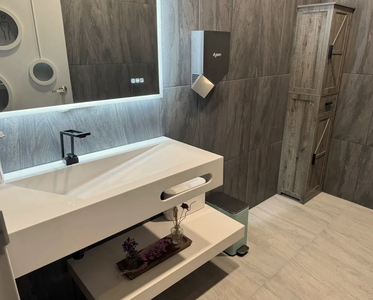 Illuminated mirror and modern sink detail at Radiant Sun Wellness.